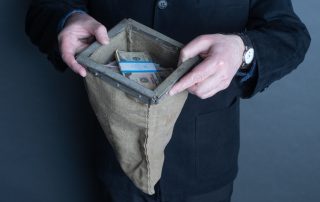 man holding bag of money