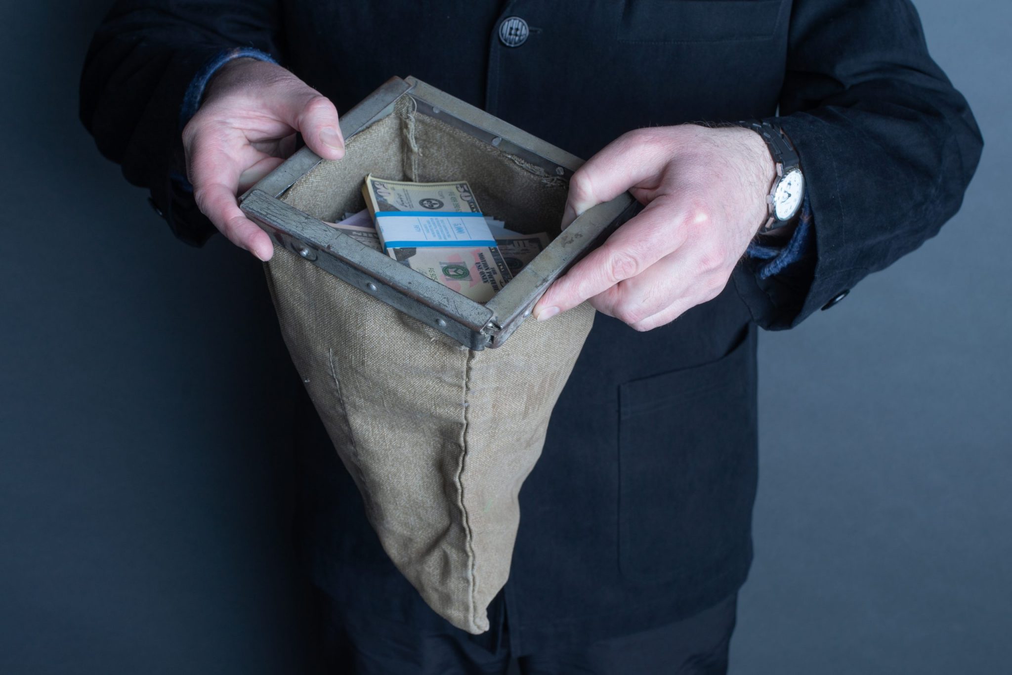 man holding bag of money