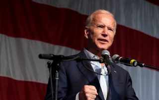 Biden speaking in front of American flag