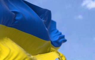 Detail of the national flag of Ukraine waving in the wind on a clear day.