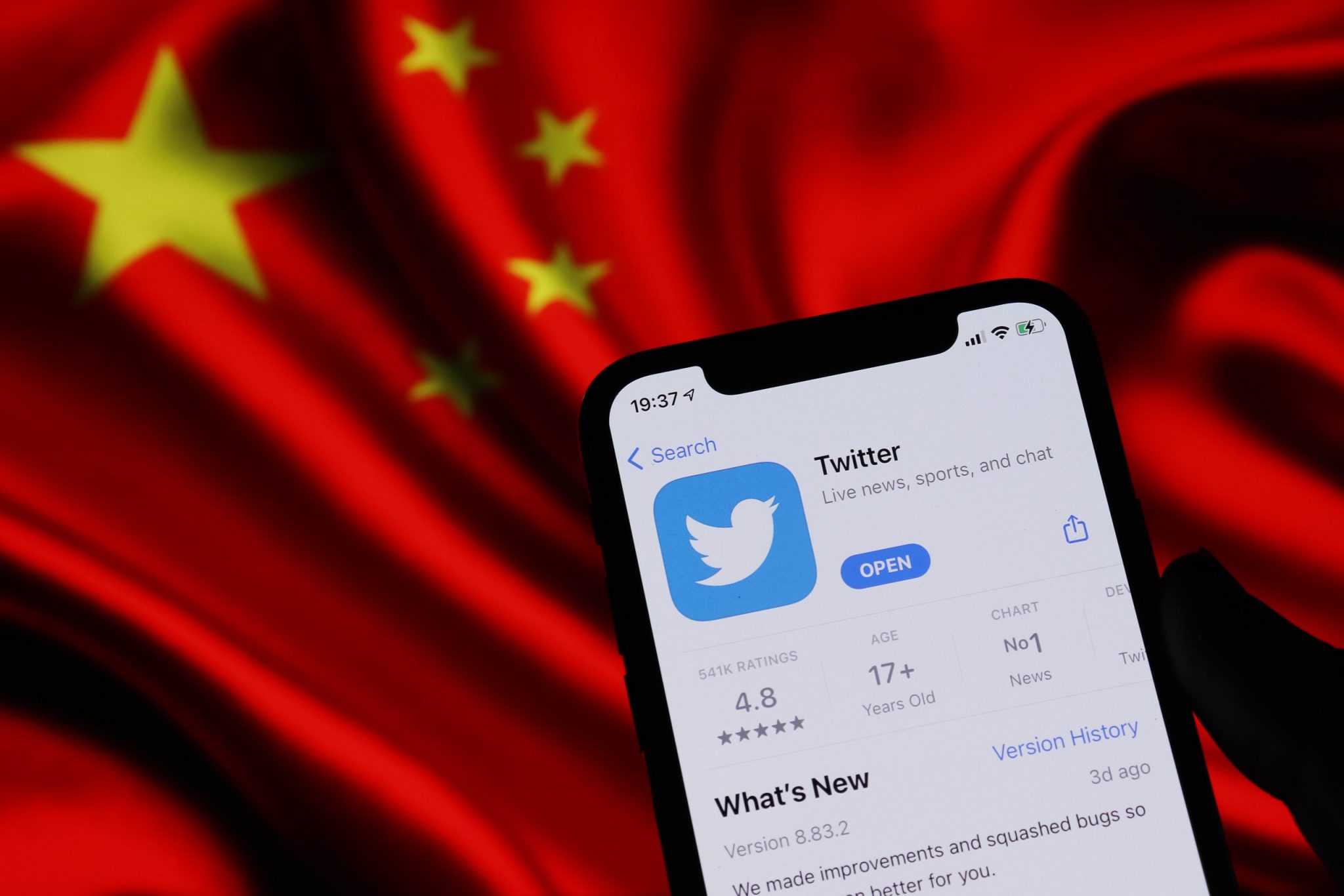 Twitter application on phone screen and China flag background