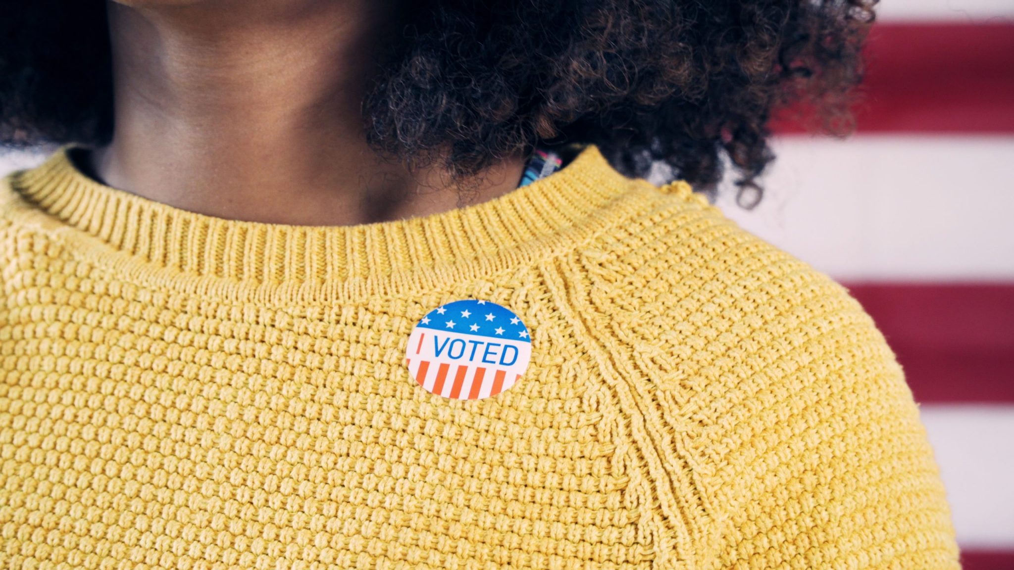 Young Gen Z Voter Wearing Sticker After Voting in Election