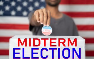 focus on Midterm election, Concept of 2022 American Midterm Elections showing by placing I voted sticker on ballot box with Midterm Election sign in front of US flag