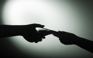 dark economy. Two hands with money