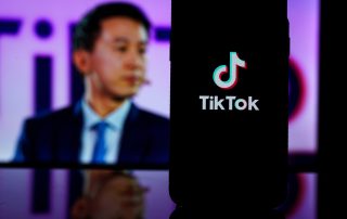 Kaunas, Lithuania - 2023 March 26: TikTok logo on screen and Tik Tok CEO Shou Zi Chew on blurred background. High quality photo
