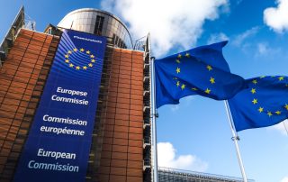 Brussels / Belgium - 11/10/2019 - European Union flags waving in wind in front of European Commission building.