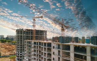 2021-05-21 Kyiv, Ukraine. Rebuilding Ukraine. Construction cranes and top of the building with construction workers