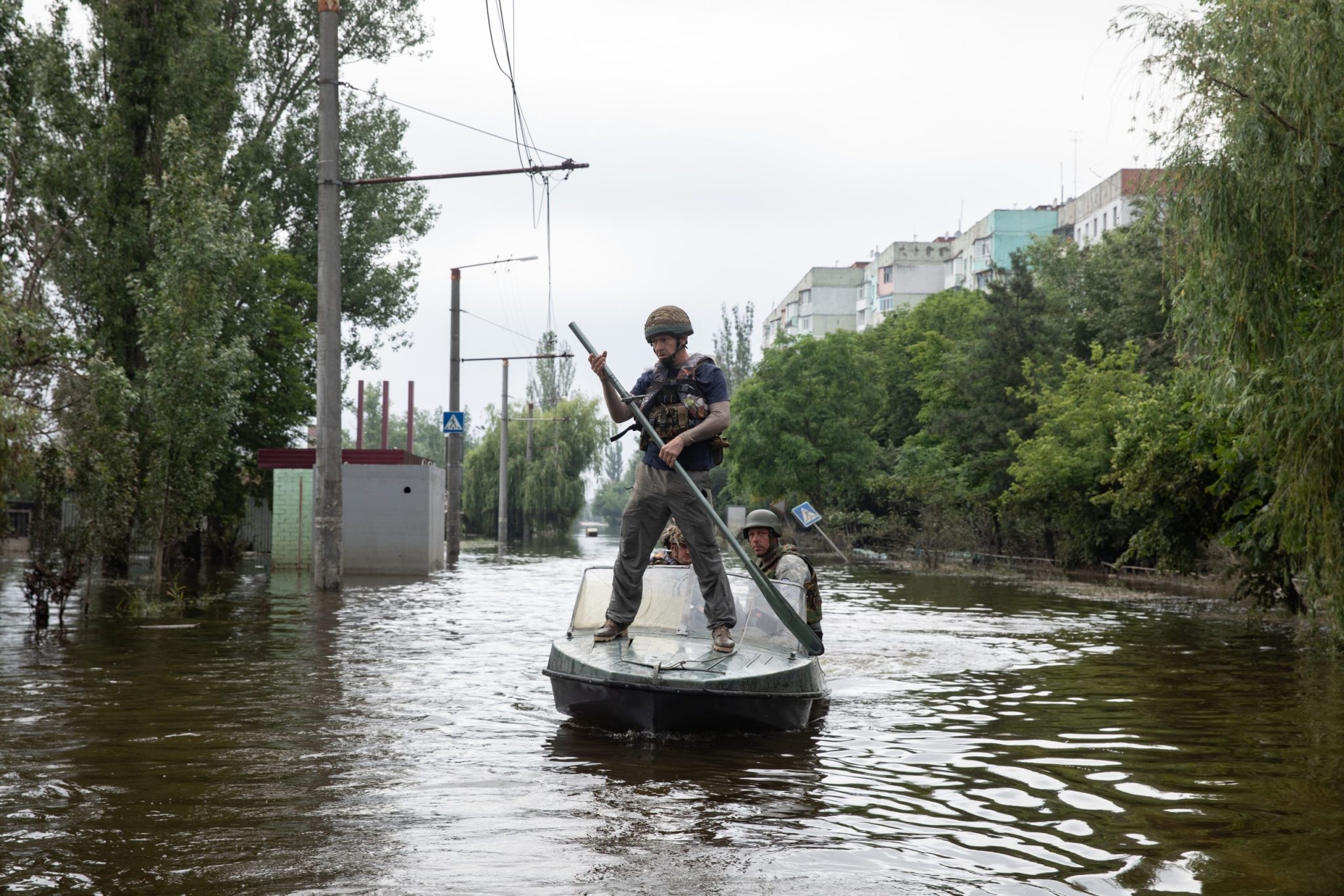 KHERSON, UKRAINE - Jun. 12, 2023: Volunteers and rescuers move by boat through flooded streets of Kherson